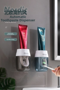 Close-up of wall-mounted automatic toothpaste dispensers in grey and blue finish