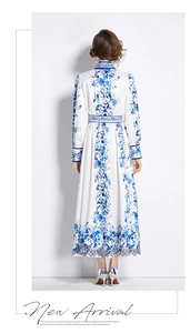 Rear view of floral printed dress with mandarin collar and matching waist belt detail