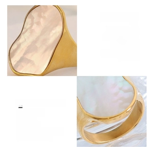 Detail view of irregular white sea shell inlay on an 18K gold-plated titanium steel ring