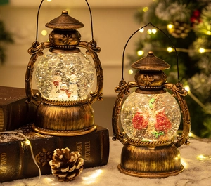 Detail of vintage Christmas lantern music box with snowman scene and warm glowing lights