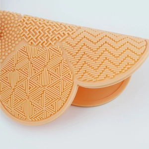 Macro view of flower-shaped silicone makeup brush cleaner with diverse textures