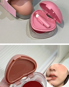 Detail of heart-shaped matte lip mud in dark red with a small portable lip brush