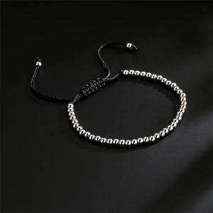 Detail of silver beads on black woven cord with adjustable drawstring closure bracelet