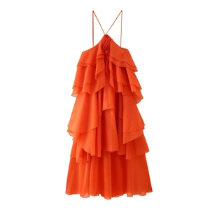 Detail of orange ruffle dress showing neck halter tie and 3D floral accent on chiffon