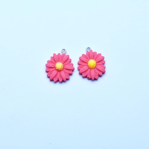 Detail of pink resin sunflower charms with metal loop for DIY jewelry making