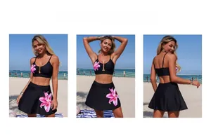 Detailed views of black bikini set with pink floral prints and swim skirt on the beach