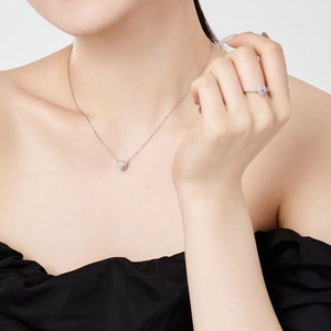 Model wearing a delicate S925 silver necklace and ring set with pink heart zirconia
