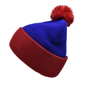 Detailed knit texture of a two-tone blue and red beanie with a decorative pom-pom
