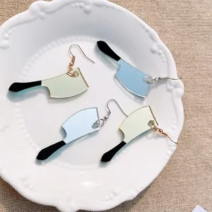 Halloween knife earrings in acrylic with mirror finish on a decorative ceramic plate