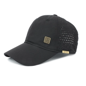 Detail of black breathable baseball cap showing laser-cut mesh and gold metal emblem