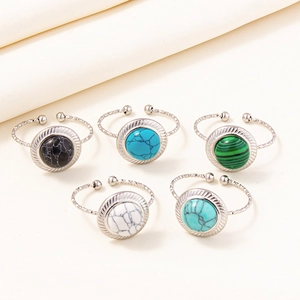 Close-up of five adjustable stainless steel rings with marble-patterned stones