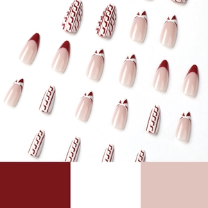 Press-on nail set with burgundy French tips and geometric patterns on white background