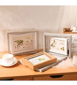 Close-up of rotating double-sided wooden photo frames in 5x7 and 4x6 inch sizes