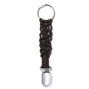 Close-up of woven hat clip for travel bag with dark brown strap and metal clasp