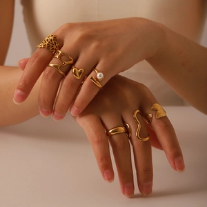 Adjustable gold titanium steel ring set with pearls and leaf designs on hand