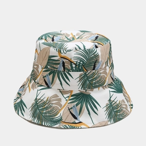 Detail of tropical palm leaf and bird of paradise print on a foldable bucket sun hat