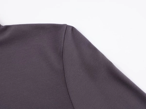 Close-up of the seam work and high-density knit texture on dark grey athletic top