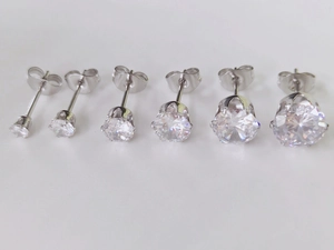 Detailed comparison of six pairs of round zircon stud earrings in various sizes with silver finish