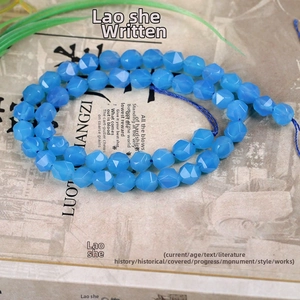 Macro detail of faceted blue agate beads with diamond-cut surface for jewelry making