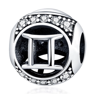 Macro view of silver Gemini zodiac charm with sparkling white crystals for DIY bracelets