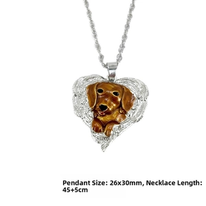 Detail of silver heart pendant with brown enamel dog motif and texture on necklace