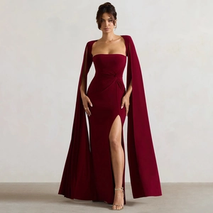 Detail view of red square neck evening gown with floor-length split and elegant cape sleeves