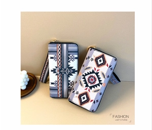 Close-up of bohemian style women's long purses with geometric patterns and wrist straps