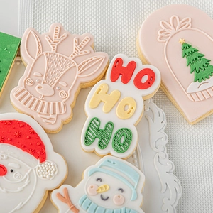 Christmas sugar cookies set featuring reindeer, Santa, tree and snowman shapes in vibrant colors