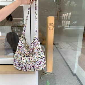 Detailed texture of hobo canvas bag with colorful purple and red floral patterns