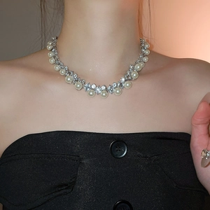 Elegant diamond-set pearl necklace on a model showing the sophisticated french vintage style
