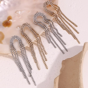 Detail of 18K gold and silver arch tassel earrings with zircon inlays and water drops