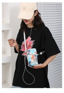 Crossbody phone bag with tropical floral print and adjustable strap shown on model