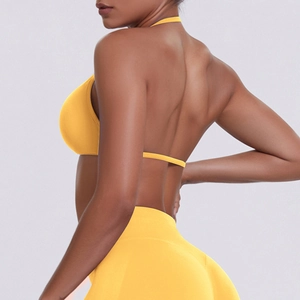 Rear view of seamless bright yellow halter sports bra and high-waisted gym leggings set