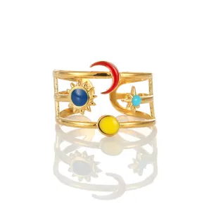 Detailed close-up of adjustable gold-plated ring with colorful enamel celestial symbols