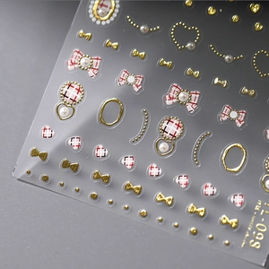 3D embossed nail stickers with red bowknot patterns and golden pearl accents