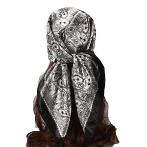 Detailed view of paisley silk scarf styled as an elegant headpiece for women