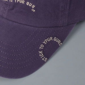 Close-up of purple cotton baseball cap with high-quality letter embroidery and stitching