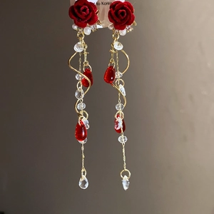 Detail of red flocked rose earrings with gold tassels, pearls and crystal droplets