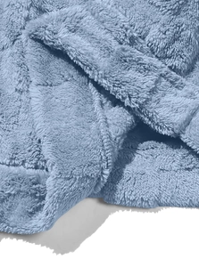 Close-up macro view of soft light blue fleece fabric with dense plush texture and warm feel