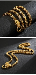 Macro detail of golden Byzantine king chain necklace featuring punk style skull clasp
