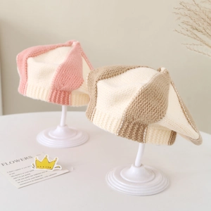 Detail of color-block knit baby berets featuring thick texture and ribbed design