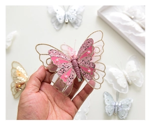 Close-up of pink layered mesh butterfly clip with colorful sequins and pearl accent