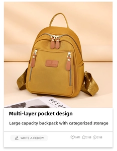 Detail view of ginger yellow nylon mini backpack with multi-layer zipper pockets and logo