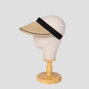 Detail of straw sun visor with black elastic headband and curved brim for UV protection