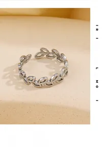 Detailed close-up of retro silver leaf ring with adjustable opening and olive branch design