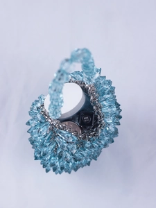 Close-up of blue beaded handbag showing internal capacity for lipstick and makeup items