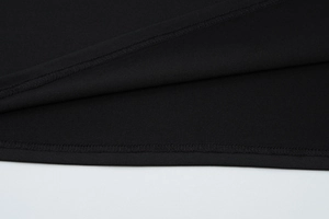 Detailed macro view of the double-stitched hem on this black deep V-neck halter dress