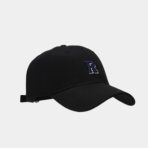 Detailed view of the letter R embroidery and twill cotton fabric on black baseball cap