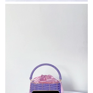 Detailed shot of purple beaded bucket bag with pink satin drawstring lining texture