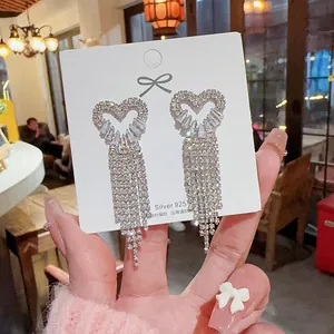 Silver 925 heart tassel earrings featuring dangling long fringe and shimmering white diamonds